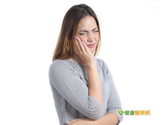 Woman suffering toothache with hand on face